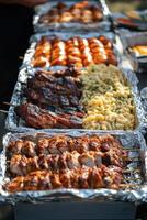 Grilled meats and pasta served at a summer outdoor barbecue gathering photo