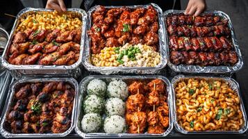 Delicious variety of food dishes arranged in silver trays at an outdoor event photo