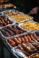 Grilled meat and cheesy pasta served at a summer barbecue gathering photo
