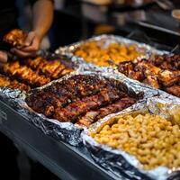 Barbecue feast with grilled meats and pasta at a street food stall photo