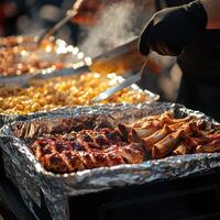 Grilling barbecue ribs and pasta at a summer outdoor gathering photo