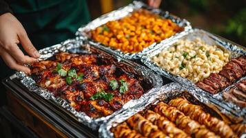 Grilled meats and side dishes served at outdoor gathering in early evening photo
