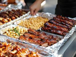 Grilled meats and sides displayed at outdoor food event in a summer setting photo