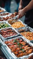 Delicious assortment of grilled meats and sides at a food event photo