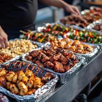 Grilled meats and savory dishes displayed at a bustling food market photo