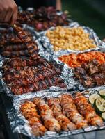 Grilling delicious skewers and barbecue at an outdoor gathering in autumn photo