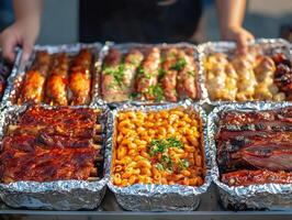 Grilled barbecue feast with assorted meats and pasta on display photo