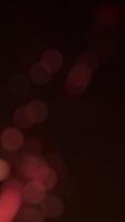 Abstract vertical bokeh background animation with fast flickering defocused warm golden bokeh light spheres. This stylish elegant motion background is full HD and a seamless loop. video