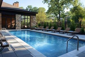 Inviting rectangular swimming pool surrounded by lounge chairs at a luxurious resort photo