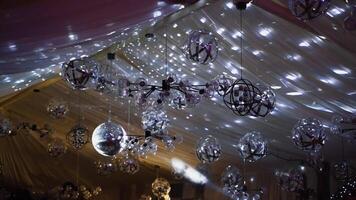 Shimmering ceiling with many glittering balls. Fantastic view of sparkling lights in the restaurant. video