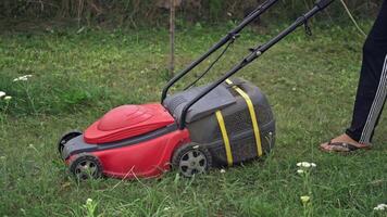 lawn mower at work on a green meadow at summertime video