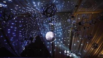 Nightclub ceiling with many shining balls. Disco ball shimmering and spinning on the glittering background. video