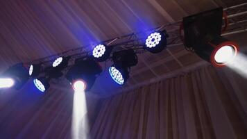 Musical spotlights. Colorful lights from projectors shimmering in the dancing hall. Modern equipment shining with different colors. video