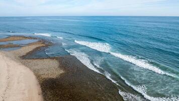 Coastal view of Trestles in San Clemente, showcasing waves and shoreline from a drone perspective photo