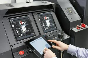 A person using an ipad in front of a machine photo