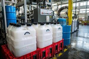 Several plastic containers filled with white liquid sitting on a crate photo