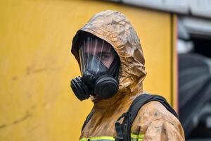 A man in a fire suit and mask photo