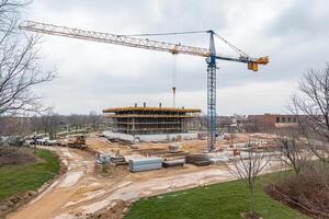 A crane is working on a building under construction photo