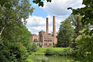 A large brick building with two chimneys photo