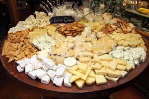 A table with a lot of cheese and crackers photo