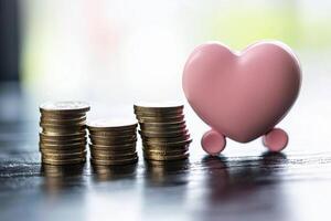 A pink heart shaped coin is sitting on top of stacks of coins photo