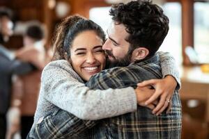 A man and woman hugging in a living room photo
