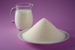 A white plate with sugar and a jug of milk photo