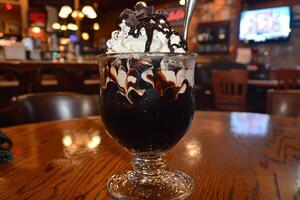 A dessert with whipped cream and chocolate on top photo