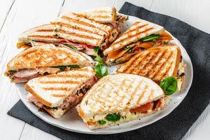 A plate with several sandwiches on it photo
