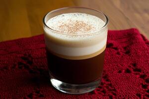 A glass of coffee and a red cloth on a table photo
