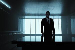 A man in a suit stands in front of a table photo
