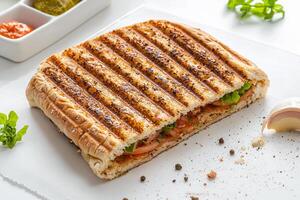 A sandwich on a plate with a side of vegetables photo