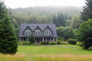 A large house sitting in the middle of a lush green field photo