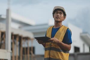 worker inspection while in Left hand hold tablet. inspector engineer using tablet. photo