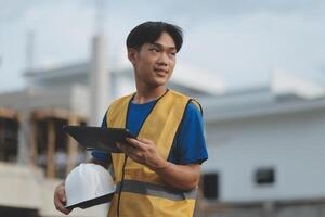 worker inspection while in Left hand hold tablet. inspector engineer using tablet. photo