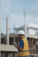 worker inspection while in Left hand hold tablet. inspector engineer using tablet. photo