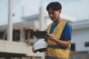 worker inspection while in Left hand hold tablet. inspector engineer using tablet. photo