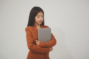 Young beautiful Asian woman in business office standing use tablet in hand, Thai girl enjoy browsing for online shopping store with copy space for advertisement, on isolated white background photo