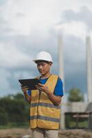worker inspection while in Left hand hold tablet. inspector engineer using tablet. photo