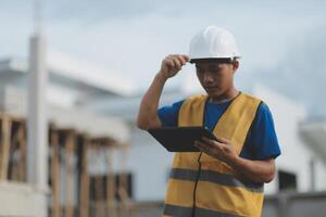 worker inspection while in Left hand hold tablet. inspector engineer using tablet. photo