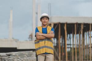 Asian man architect holds blueprint with skyscraper background, Asian male architect builder engineer design working planning confident outdoors in construction site. photo