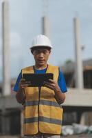 worker inspection while in Left hand hold tablet. inspector engineer using tablet. photo