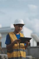 worker inspection while in Left hand hold tablet. inspector engineer using tablet. photo