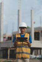 worker inspection while in Left hand hold tablet. inspector engineer using tablet. photo