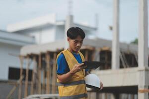 worker inspection while in Left hand hold tablet. inspector engineer using tablet. photo