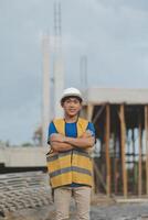 Asian man architect holds blueprint with skyscraper background, Asian male architect builder engineer design working planning confident outdoors in construction site. photo