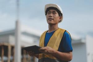 worker inspection while in Left hand hold tablet. inspector engineer using tablet. photo