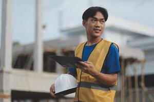 worker inspection while in Left hand hold tablet. inspector engineer using tablet. photo