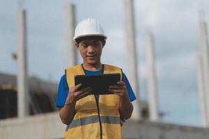 worker inspection while in Left hand hold tablet. inspector engineer using tablet. photo