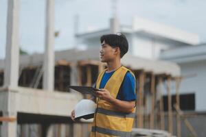 worker inspection while in Left hand hold tablet. inspector engineer using tablet. photo